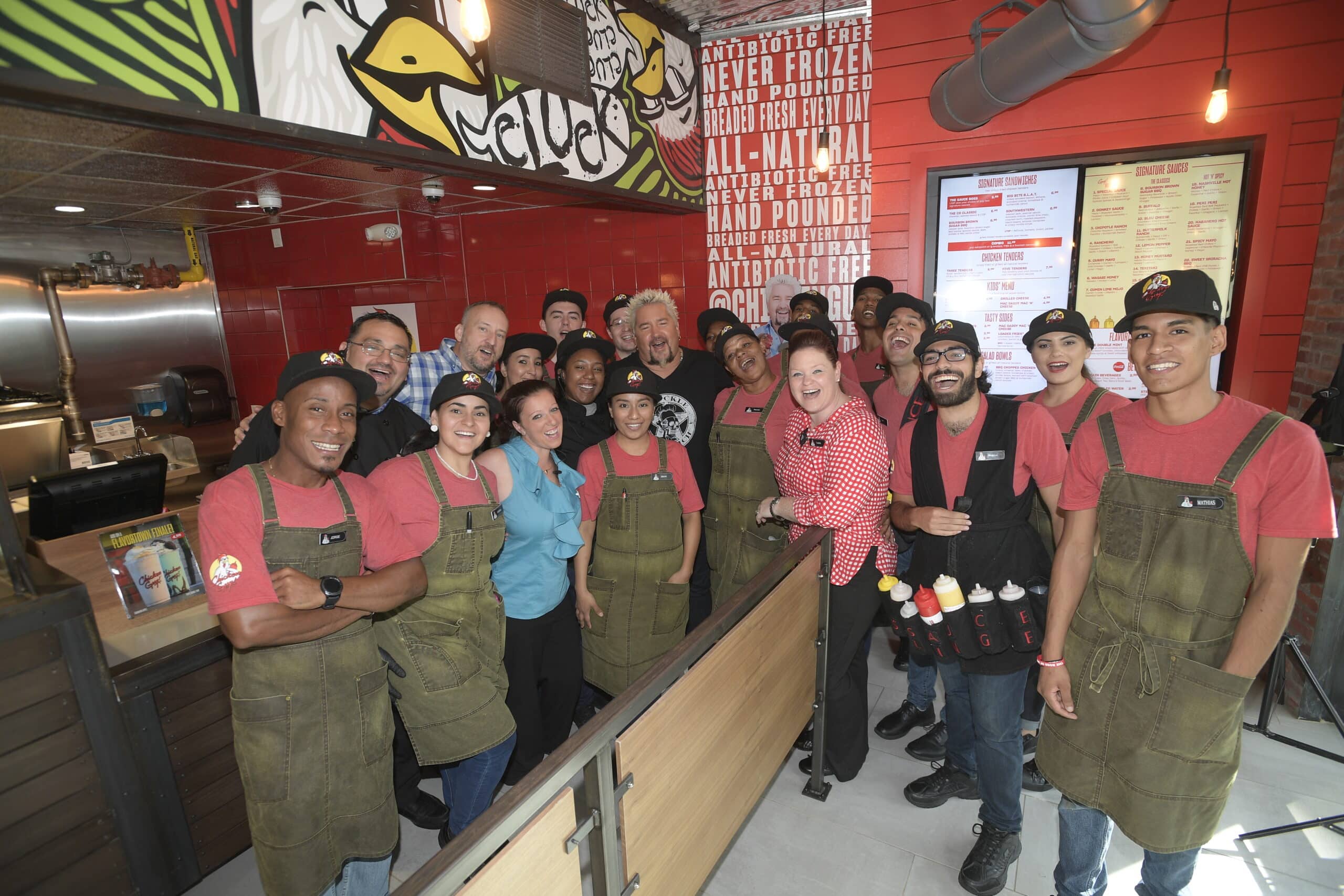 Guy Fieri surrounded by Chicken Guy! employees